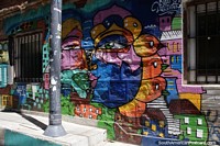Large colorful face painted on this shopfront in Valparaiso to help brighten your day. Chile, South America.