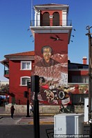 Woman with animals and items buried underground, large mural on a building in La Serena. Chile, South America.