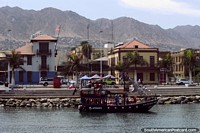 Iconic buildings along the waterfront and a mountainous backdrop in Antofagasta. Chile, South America.