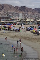 People enjoy the beach on a hot day in Antofagasta. Chile, South America.