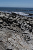 Irregular shaped and textured rocks on the coast in Curanipe.