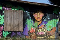 Woman holding a basket of fruit, mural in Conaripe.