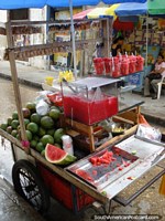 Larger version of Watermelon pieces in a cup and juice on a cart in Cartagena.