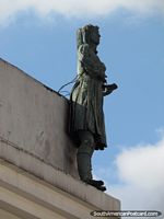 Sculpture of woman figure on building in historical Bogota. Colombia, South America.