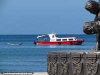Larger version of View of a boat from beside a monument on the Santa Marta waterfront.