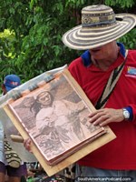 Colombia Photo - Man sells drawings of indigenous people in Taganga.