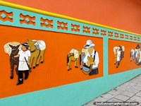 Bright orange skirting depicting life of the locals in central Guatape. Colombia, South America.