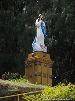 A religious statue with 2 heads at its feet on the hill in Guatape. Colombia, South America.