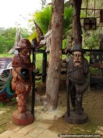 2 wooden sculptures of elder men, art in Salento. Colombia, South America.