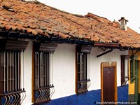 Facades and tiled roofs of houses in La Candelaria in Bogota. Colombia, South America.