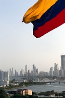 Colombian flag flies over the new city of Cartagena from San Felipe Castle. Colombia, South America.