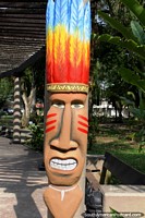 Monument in the park in Leticia of a figure with colorful feathers on his head.
