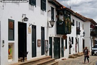 Whitewashed buildings and shops with wooden balconies and doors in Villa de Leyva. Colombia, South America.