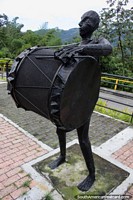 Iron man bangs the big bass drum, one of several musical figures at the Park of Music in Ibague. Colombia, South America.