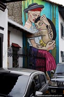 Man and woman with tattoos embrace, amazing street art in Cali. Colombia, South America.