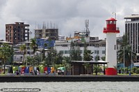 Lighthouse, city and waterfront in Buenaventura, view from a boat. Colombia, South America.