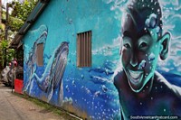 Mural de um rapaz jovem que nada com baleias em Juanchaco - uma praia ao norte de Buenaventura. Colômbia, América do Sul.