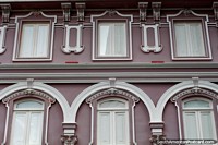 Nice windows and arches, a well-kept historic facade in Manizales. Colombia, South America.