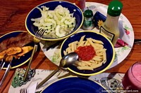 Dinner at Tinamu, meat, tomato pasta, platano, cucumber salad and juice, Manizales. Colombia, South America.