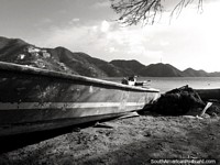 Boat and nets on the beach, peaceful bay in Taganga, black and white. Colombia, South America.