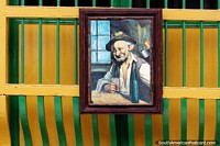 Larger version of Man having a drink, painting outside a shop in Jardin.