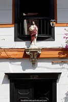 Religious icon, part of the facade above a shop entrance in Jardin. Colombia, South America.