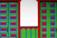Pair of doors, almost identical, green with red squares, blue trim, Salento. Colombia, South America.
