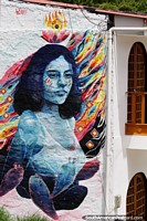 Girl surrounded by cactus, amazing huge colorful mural on a house in Salento. Colombia, South America.