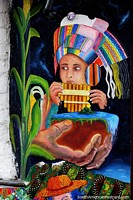 Menino com toucas multicoloridas sopra cachimbos de madeira, grande arte de rua em Pasto. Colômbia, América do Sul.