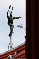 Juggling while riding a unicycle, bronze figure above Plaza del Chorro Quevedo in Bogota. Colombia, South America.