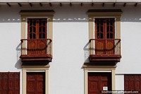 Building with a pair of wooden balconies and doors at the Plaza de la Villa in Sogamoso. Colombia, South America.