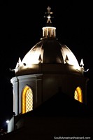 The cathedral at night, yellow light shines from the arched windows of the dome in Tunja. Colombia, South America.