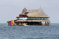 Hostel with a large hammock room on the top floor in the middle of the sea off Tintipan Island. Colombia, South America.