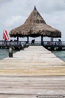Wooden boardwalk of the jetty to the waiting station for boats at Tintipan Island. Colombia, South America.