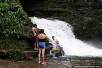 Young people enjoy the cool waters flowing through the hot jungle in Mocoa. Colombia, South America.