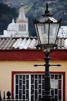 Streetlamp in Pamplona with distant churches and countryside. Colombia, South America.