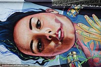 Street art in Pamplona, large head of a woman painted on a city wall.