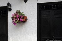 Giron, a place with nice facades, lamps and flower pots outside the houses. Colombia, South America.