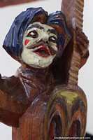 La turumama y los compinches (1996), wooden carving of a clown playing guitar, museum in Pasto. Colombia, South America.