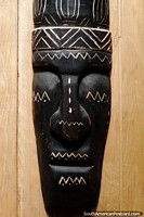 Black and white mask, long face with painted designs, museum in Mocagua, Leticia. Colombia, South America.
