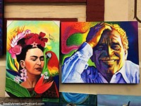 Man smiling and a woman with a macaw, paintings for sale in Bogota.