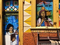 Wooden facade of a cafe painted beautifully with people and color in Bogota. Colombia, South America.