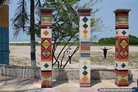 Tiled columns artwork in front of the beach and ocean in Riohacha.