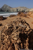 Interesting rock formations on the beach with hills at Pilon de Azucar in Cabo de la Vela.