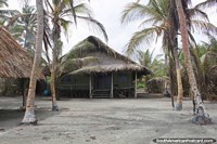 Large house with a thatched roof in front of the beach in San Bernardo del Viento.
