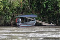 Boat moored and a path from the river up to the jungle house in the Amazon.