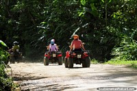 Larger version of People riding buggies along the road between the town and the river in Mindo.