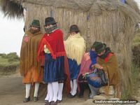 The local women of Quilotoa dressed in colorful traditional clothing, hats and shoes.