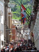 Busy streets and many people in Quito historical area.