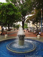 Blue fountain and a park along the Malecon in Guayaquil. Ecuador, South America.